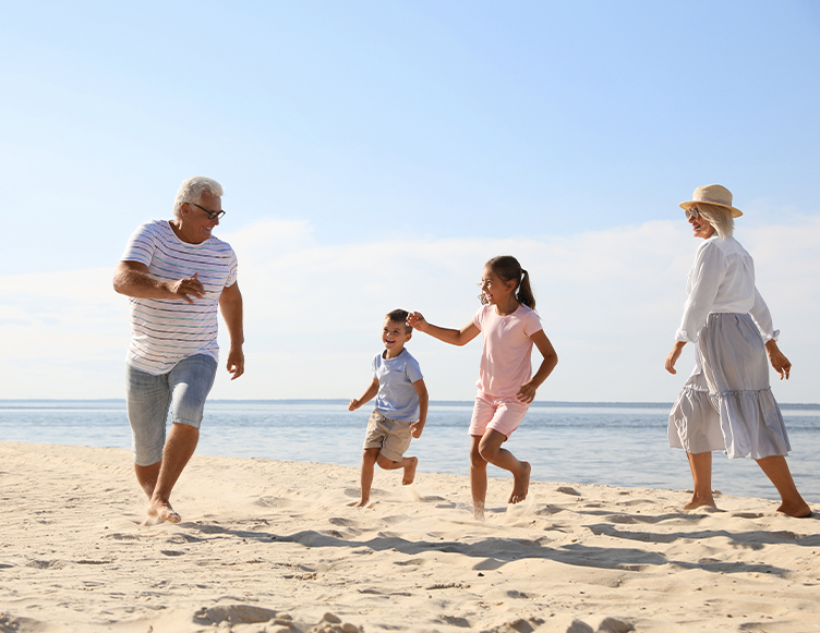 A smiling family running on a beach